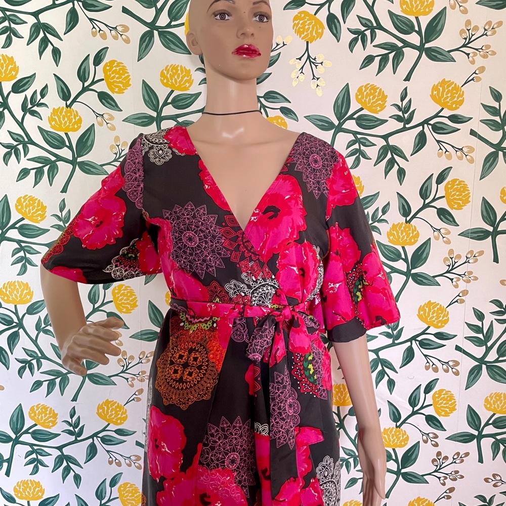 Floral hi-low Romper with tie belt and skirt.